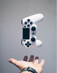 game controller in the air above a hand